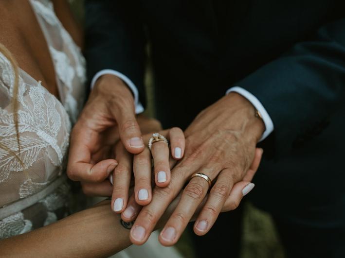 Adam-Anna-Holding-Hands-Wedding-Bands
