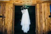 Brides-Dress-Hanging-From-Barn-Door-JJ