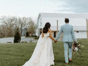 Bride-Groom-Stroll-Through-Meadow-Overlook-Barn