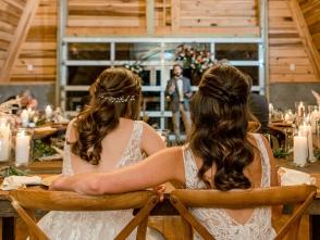 Brides-Listening-To-Speech-Under-Chandelier