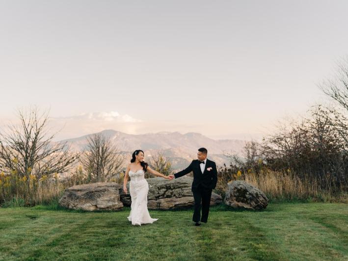 Bride-Groom-Holding-Hands-Mountain-Background