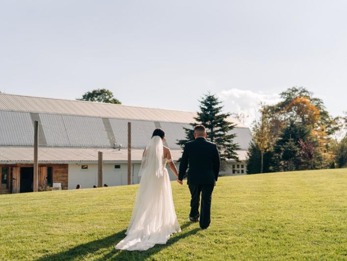 Nkaujyi-Tou-Walking-Across-Meadow-To-Barn