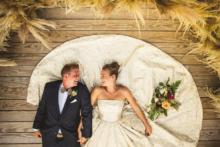 Zach-Sarah-Laying-on-Ceremony-Platform-Holding-Hands    